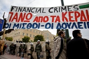A banner is held in front of the Greek Parliament during a protest of the journalist's union ESIEA. The banner reads
