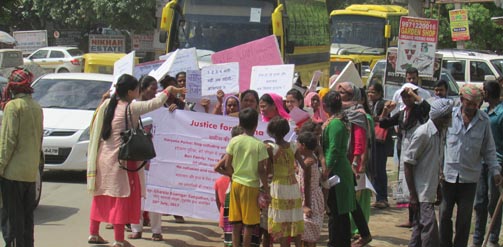 Local women hold signs in protest against the rape and murder of a domestic worker in India.