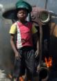 Boy stand by a burning car in the 2008 Mozambique riots Boy stand by a burning car in the 2008 Mozambique riots.