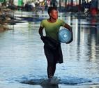 Woman fetching drinking water in a flooded street in Haiti Woman fetching drinking water in a flooded street in Haiti
Credit: Panos.Dieter Telemans