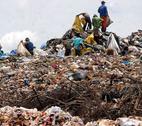 Waste pickers in Brazil Waste pickers on top of a large waste dump in Brazil, collecting plastic bottles for recycling.