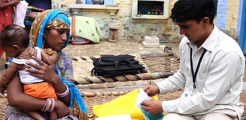 A woman and child is seen by a doctor in India.