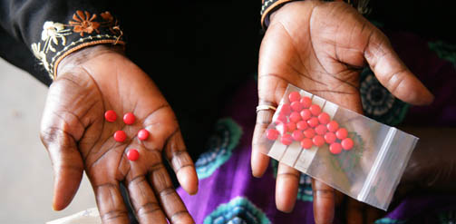 A woman being shown how to use antibiotics in Mali.