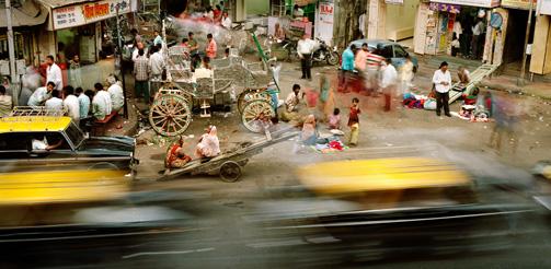 INDIA Mumbai (Bombay), Maharashtra
Taxis pass a homeless family living on a street in a Muslim quarter of the city centre near Mohammed Ali Road.
Credit: Martin Roemers / Panos