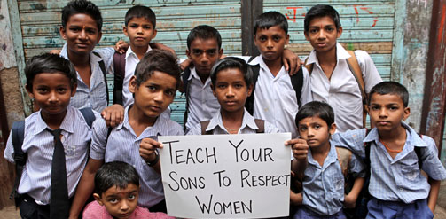 Boys hold a sign saying 'teach your sons respect for women'. Photo credit: Tash McCarroll. UN Women Asia and the Pacific