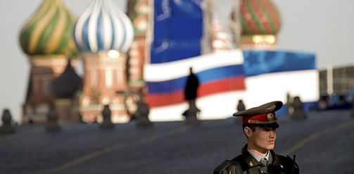 policeman stands in Red Square in front of Saint Basil's Cathedral. Credit: Bjoern Steinz / Panos