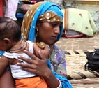 India_health_teaser_image A woman and child consult a doctor in India.