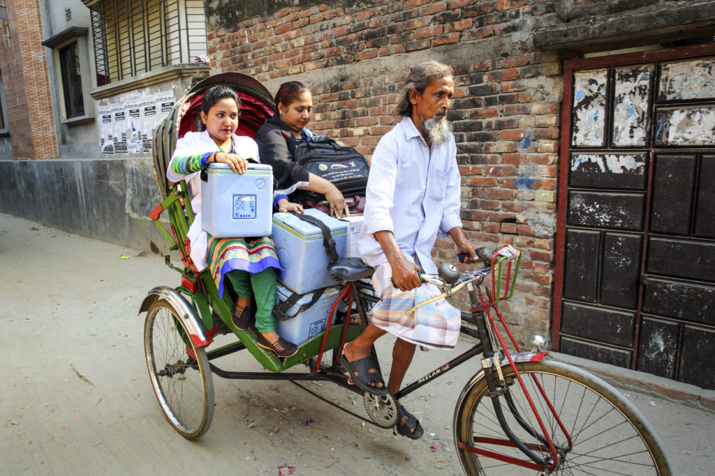 Muna, a Community Health Care Provider, transports vaccinations, kept in cool boxes, by rickshaw to the distribution point as part of the Expanded Program on Immunisation (EPI).