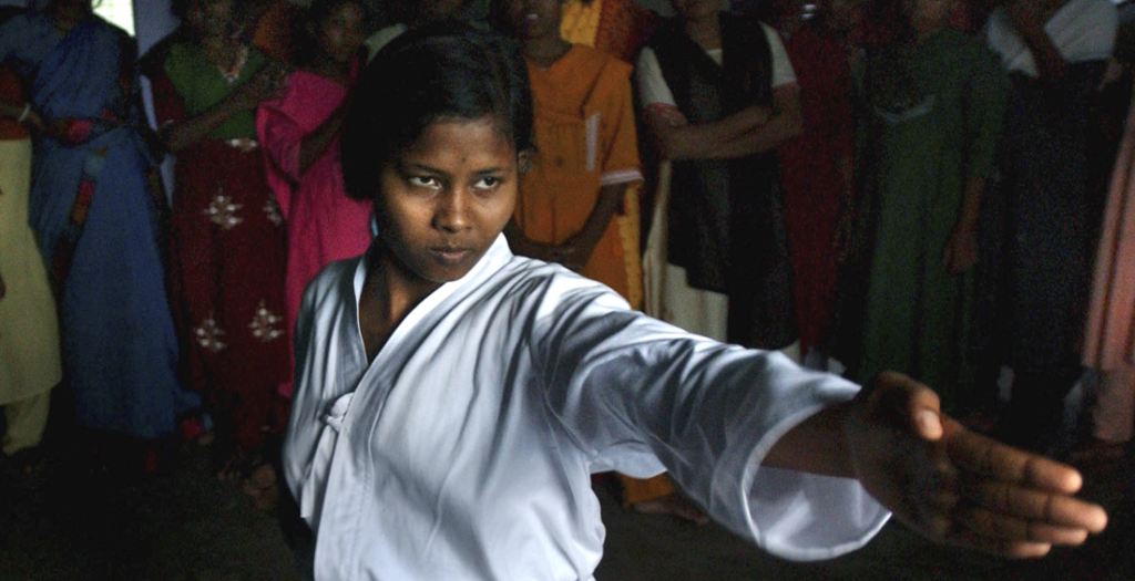 A young Dalit woman teaches karate to other low-caste girls at a women's education centre in Bihar, India. Ami Vitale, Panos Pictures.