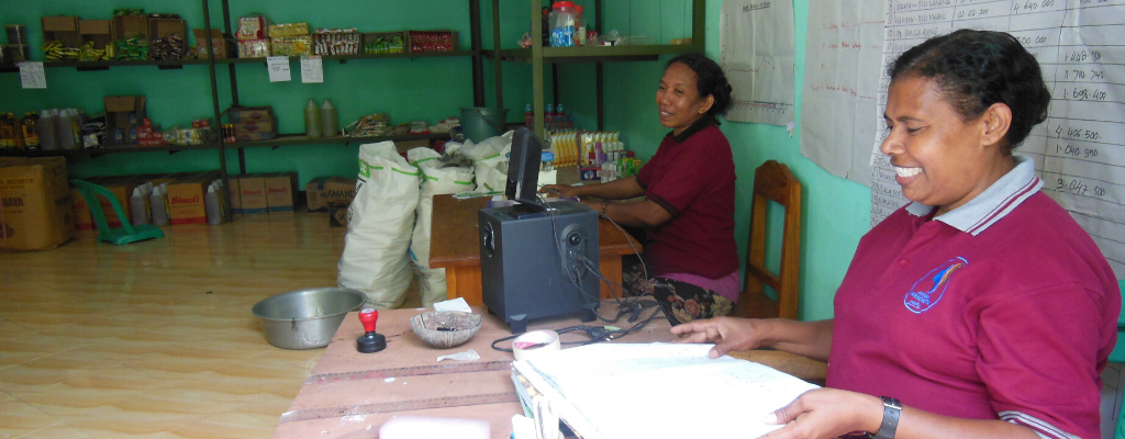 Two women at the Lodan'Doe cooperative, sorting papers