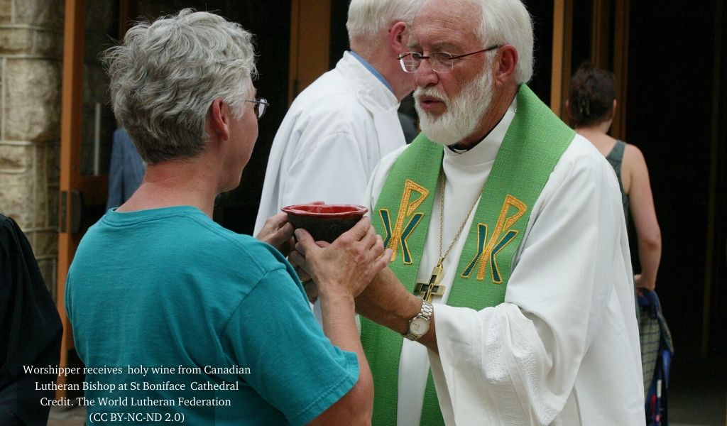 Worshipper receiving the cup from Canadian Lutheran at St Boniface Cathedral.