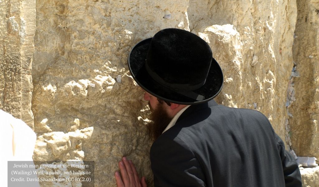 Man praying at the Western Wall, a Jewish holy site