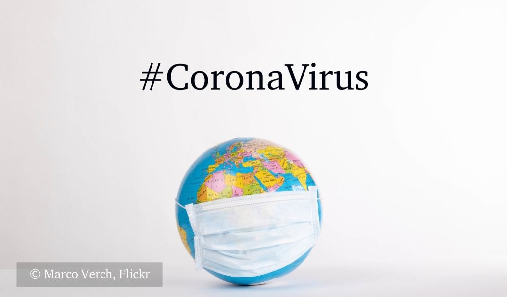 Globe with medical mask and #CoronaVirus text on white background