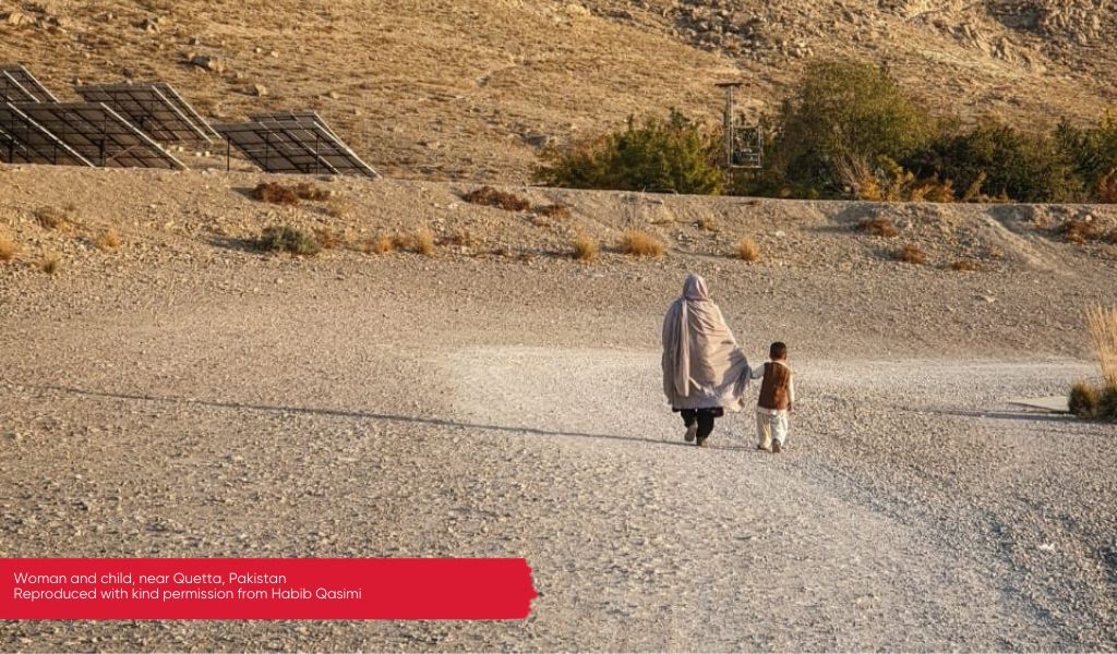 Woman and child on a dusty road in Balochistan, Pakistan