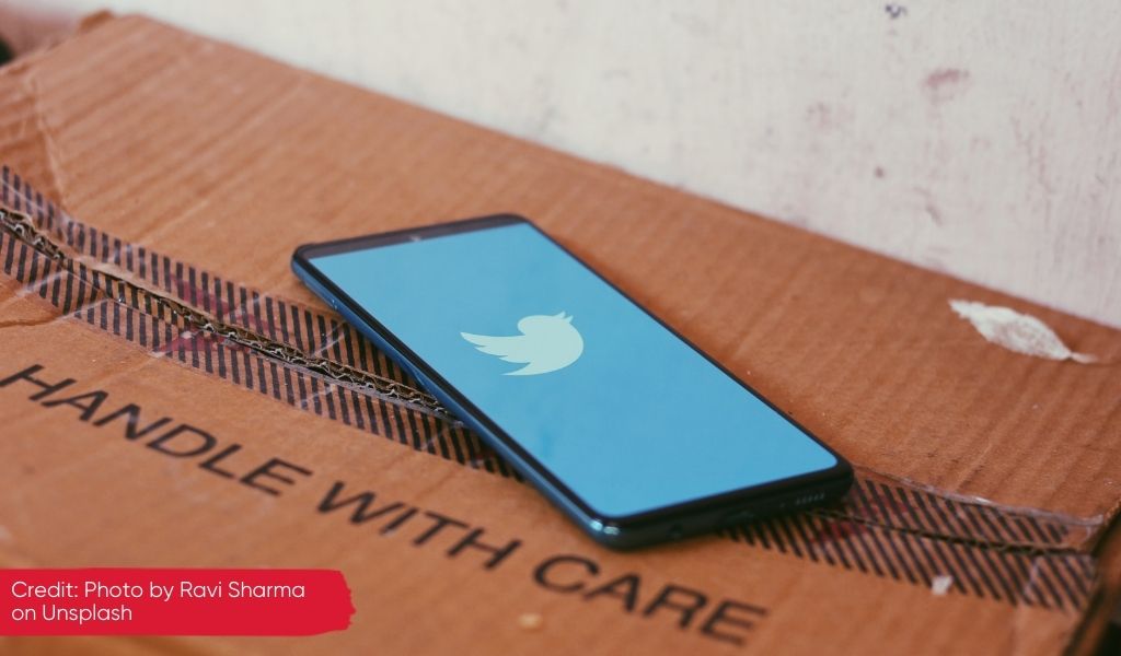 Phone with Twitter logo on a box saying Handle with Care