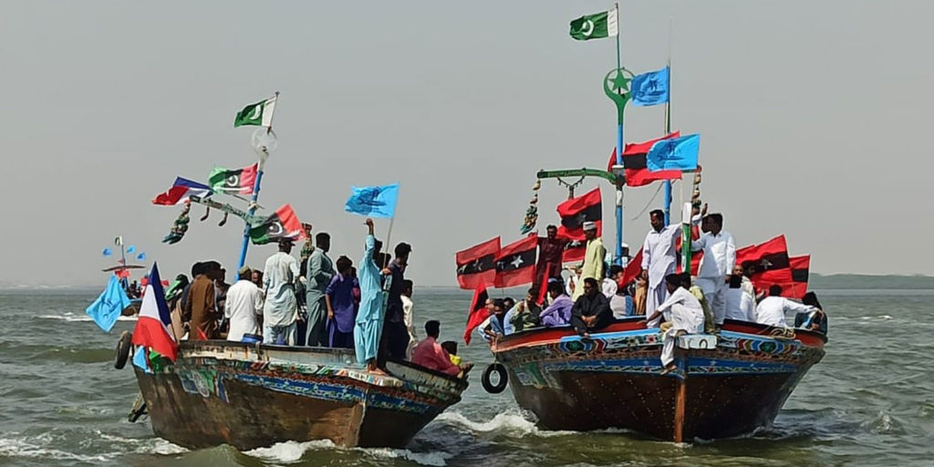 Members of the Pakistan Fisherfolk Forum hold a protest at sea in September 2020 against government plans that threatened their livelihoods.