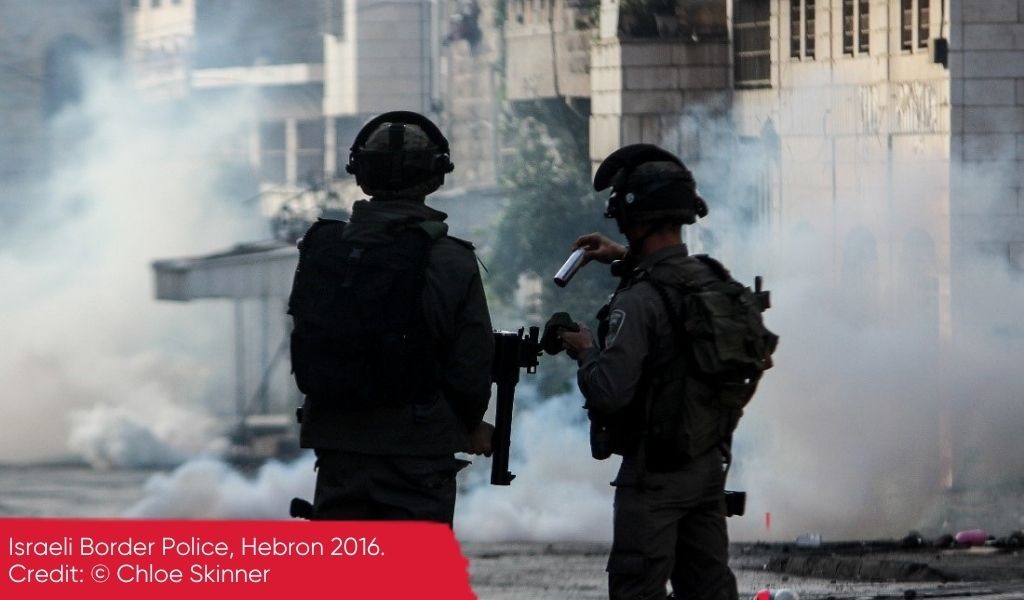 Two Israeli Border Police reload amidst onslaught of teargas fired into a residential area of Hebron in 2016.