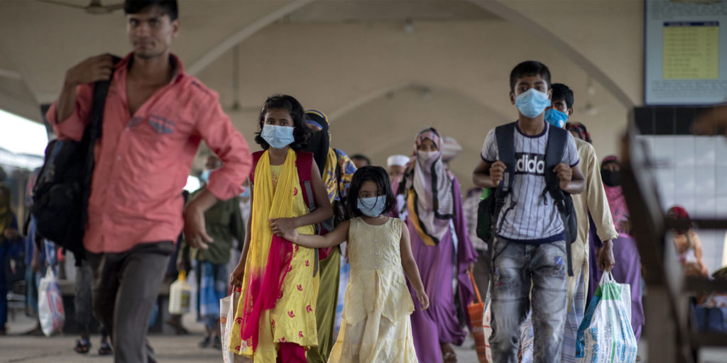 Passengers wearing facemask just came out from a train at Kamalapur railway station in Dhaka.