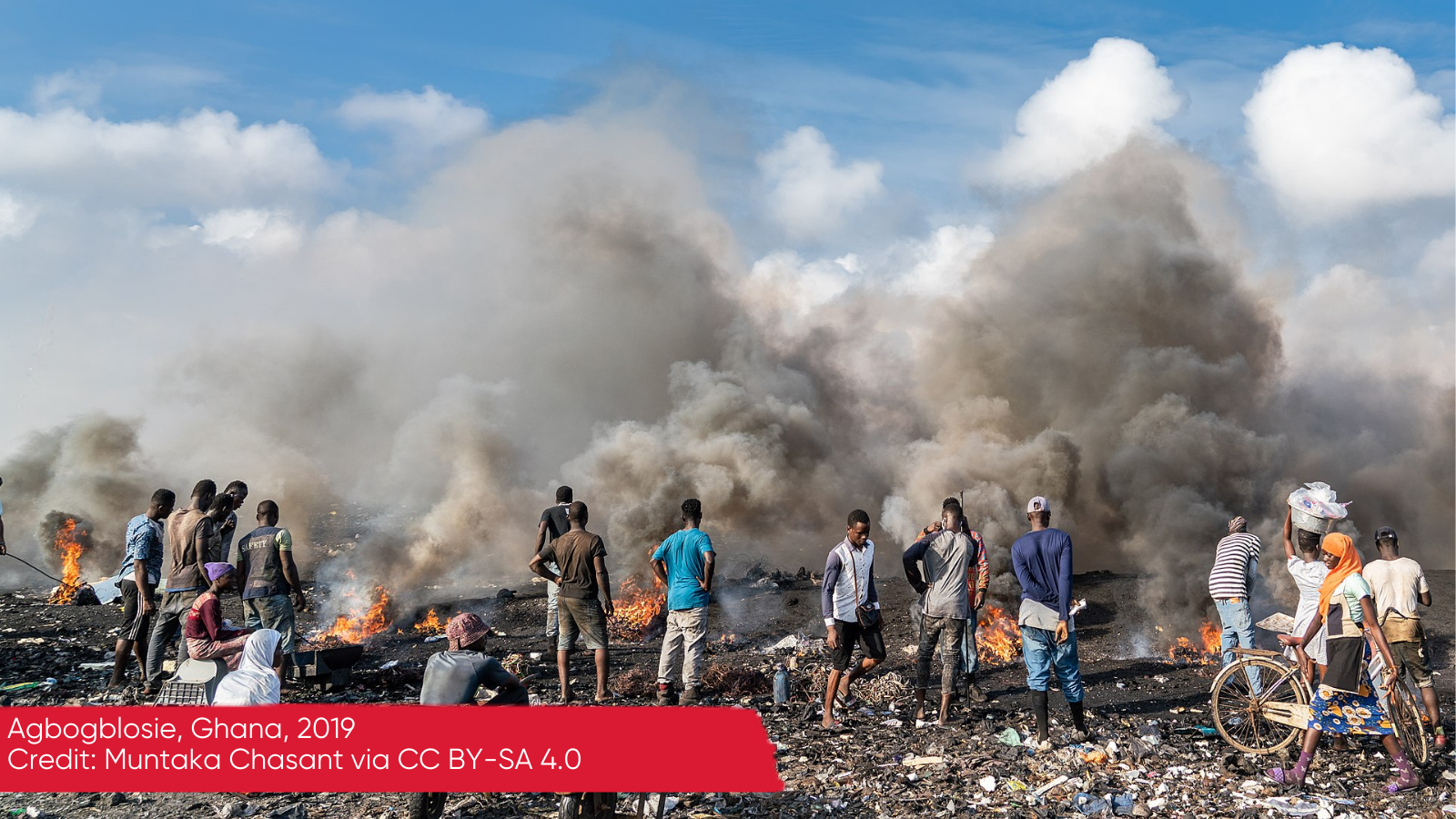 Young men burning electrical wires to recover copper at the agbogbloshie waste site, Ghana