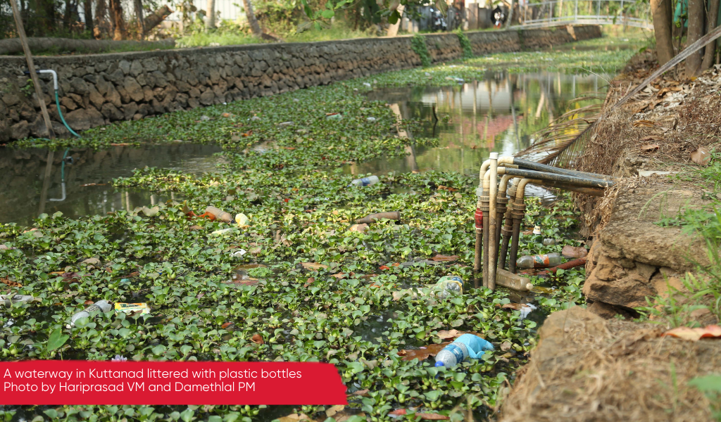 A large waterway littered with plastic waste, Kuttanad