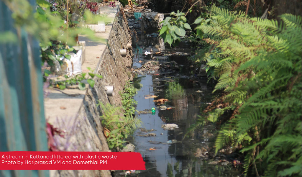 A small waterway littered with plastic waste, Kuttanad