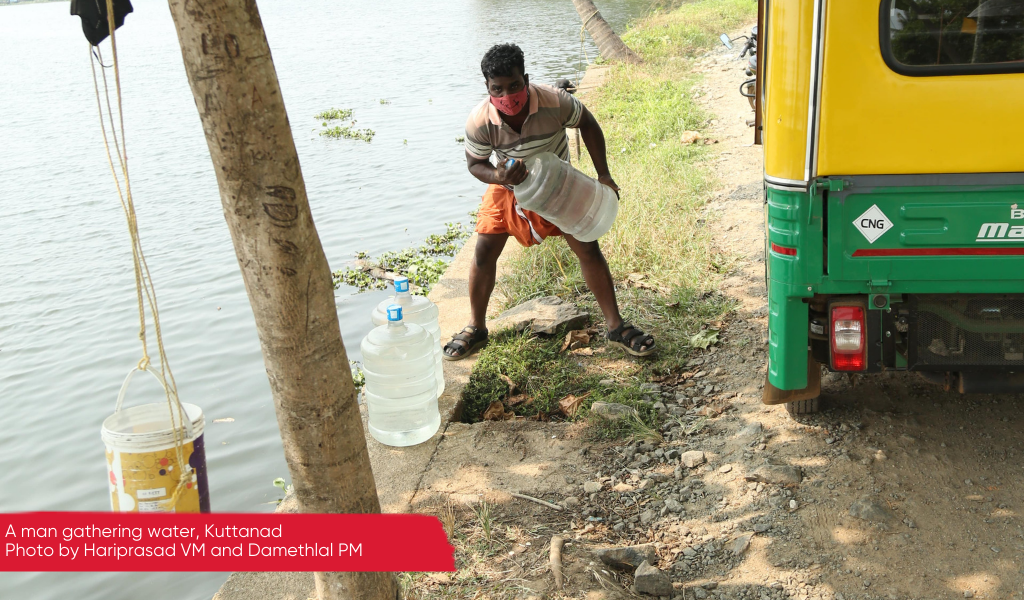 A man collecting water in Kuttanad, Kerala
