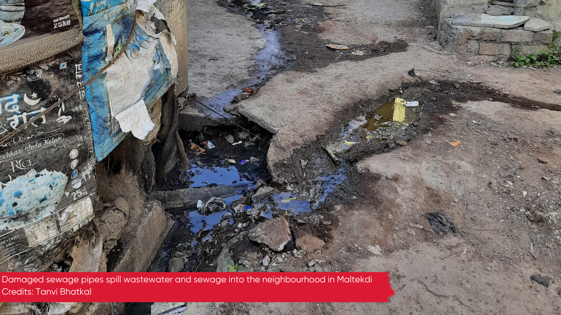 Photo of a damaged sewage pipe spilling wastewater into the lane