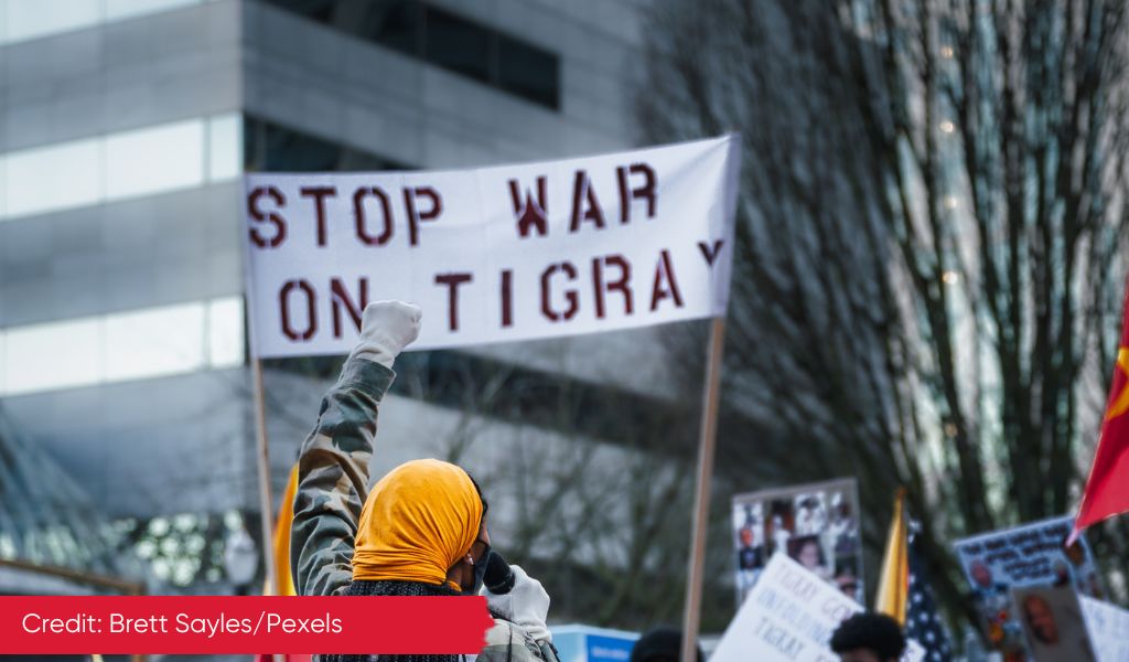 Protesters holding up a banner reading Stop War on Tigray