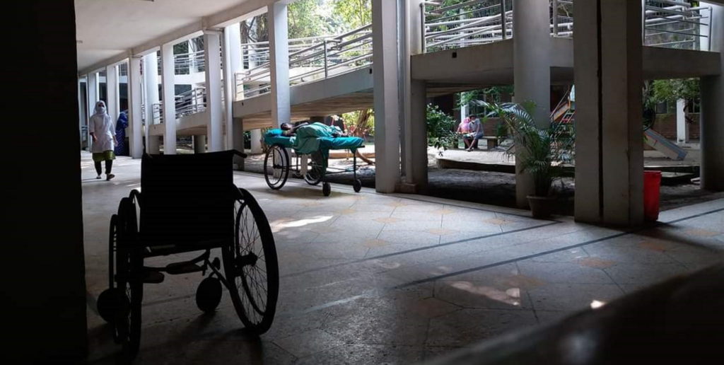 A silhouette of a wheelchairin a health centre