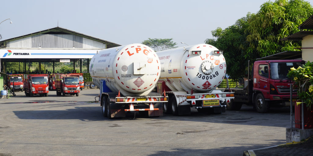 Propane and Butane LPG (liquefied Petroleum gas) refill station with some distribution trucks and big tanks owned by Pertamina national oil company in Yogyakarta, Indonesia.