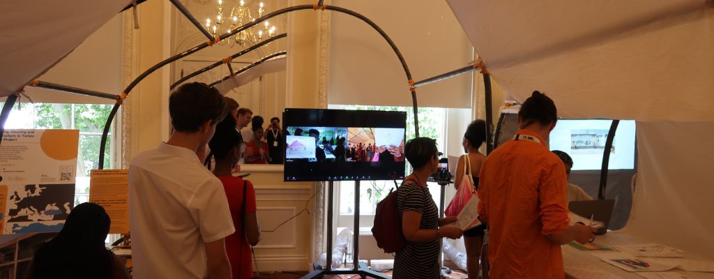 Schools children at the exhibit - watching the live link on a screen at the British Academy Summer Showcase.
