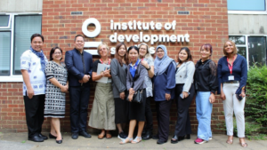 Group of Southeast Asia university leaders standing with IDS Colleagues. Photo by James Andrews, IDS