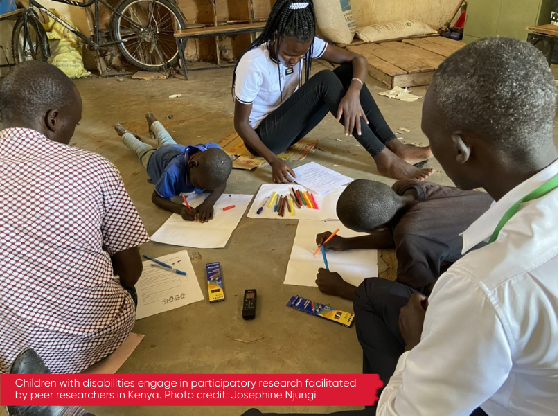 A photo of three adults and two children sitting on the ground. The children are drawing on paper with coloured pens whilst the adults watch them. There is text layered over the photo on a red background that reads 'Children with disabilities engage in participatory research facilitated by peer researchers in Kenya. Photo credit: Josephine Njungi'.