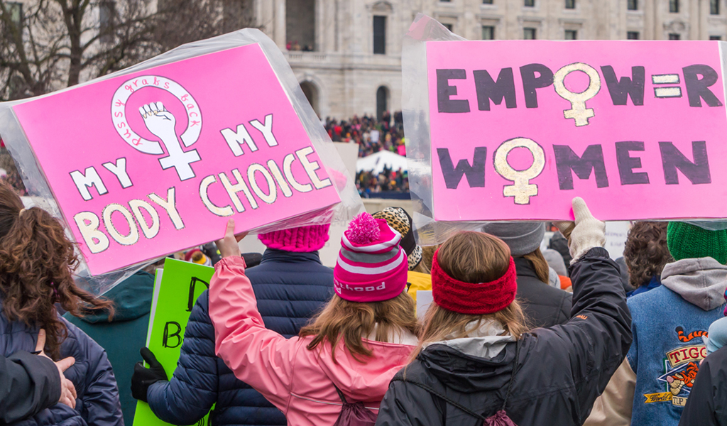 Unidentified participants carrying pro-Women banners at a Women's march in Minnesota.