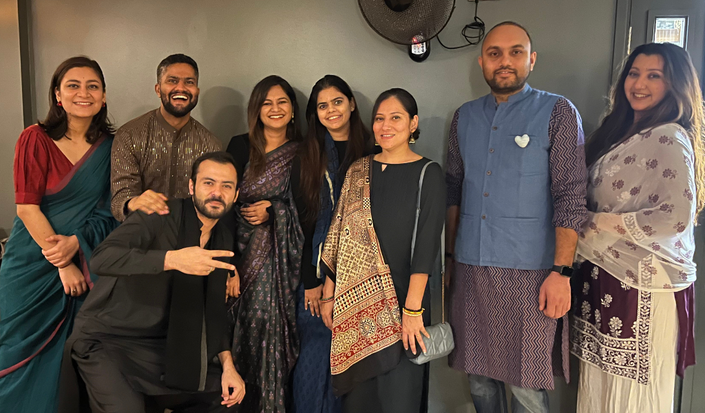 A group of eight students, some of them in traditional Indian dress.