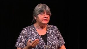 A woman giving a talk on stage