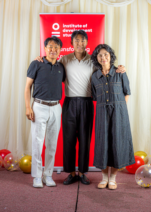 A photo of three people looking straight at the camera.
