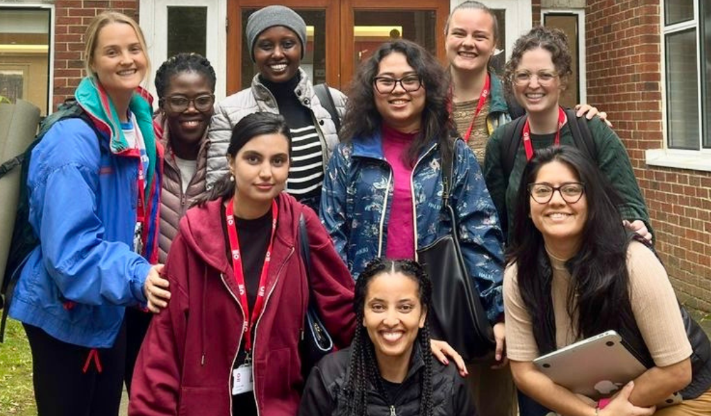 Nine students posing outside of IDS.