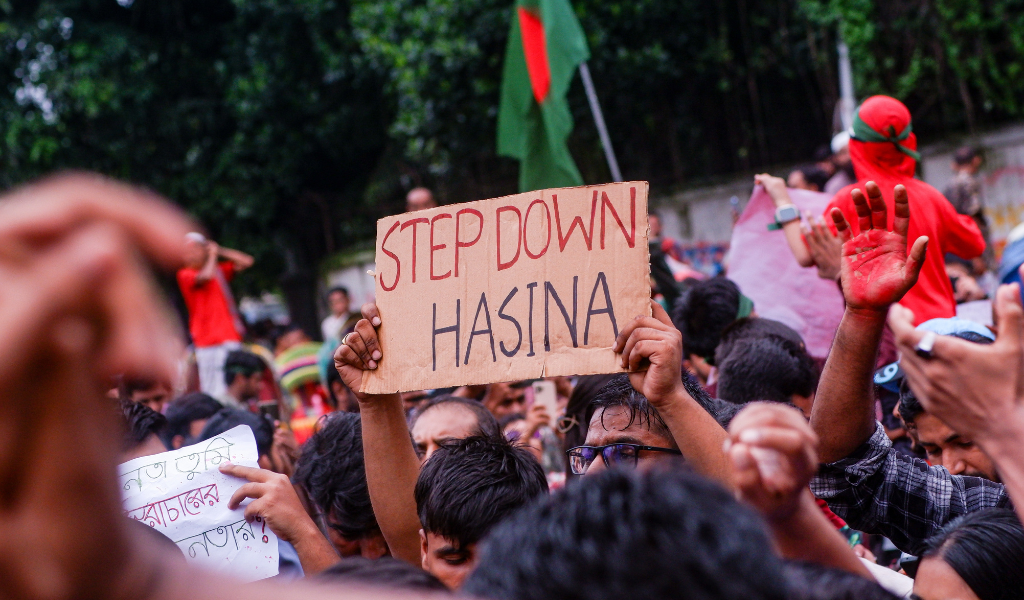 Protestors with placard 'Step down Hasina'.'