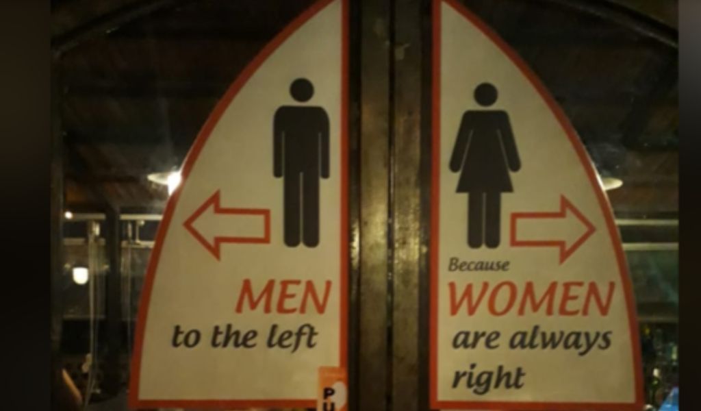 A photo of a restroom sign. The sign on the left hand door has a sign that says "men to the left" and the right hand door has a sign that says "because women are always right".