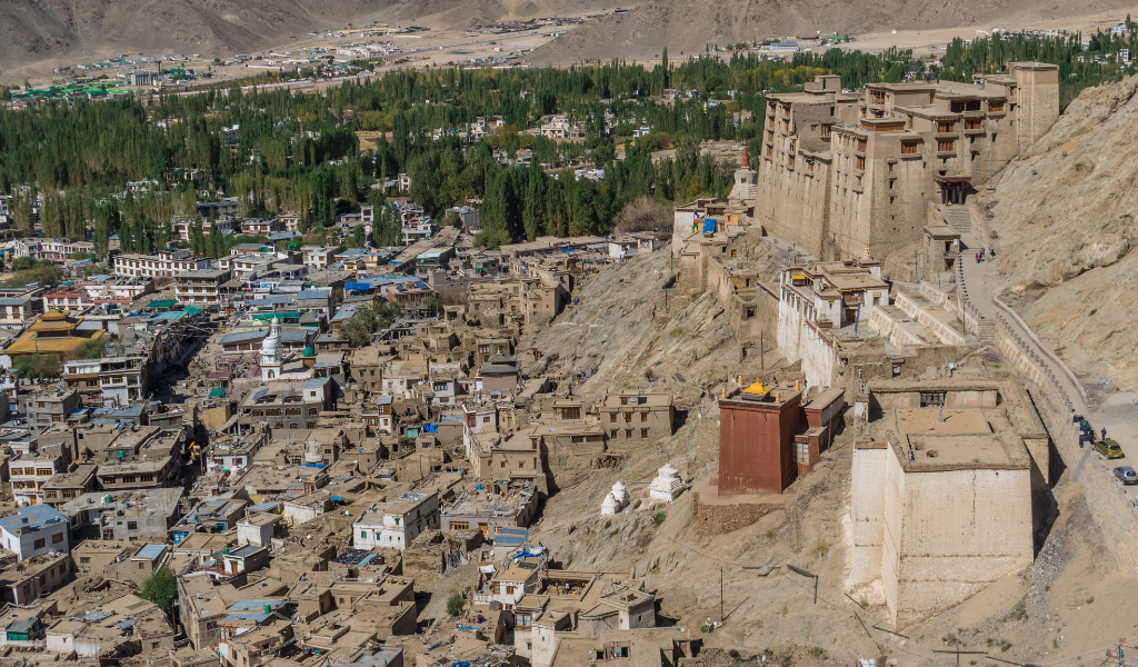 small houses and building piled up around the valler with light yellow colour as the background