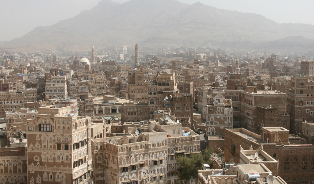 Skyline of the Old City of Sana'a, a UNESCO World Heritage Site, with the surrounding mountains in the background.