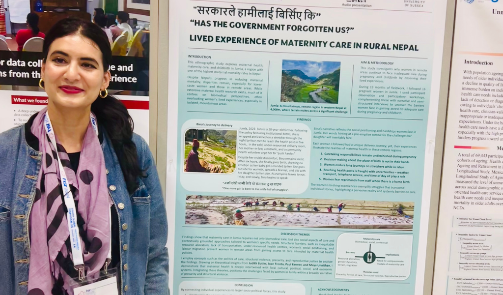 PhD researcher standing infront of a board 