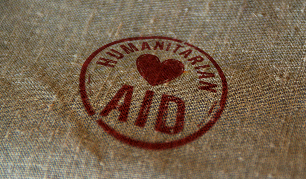 This is a photo on a linen bag with the words Humanitarian Aid stamped on it in red.
