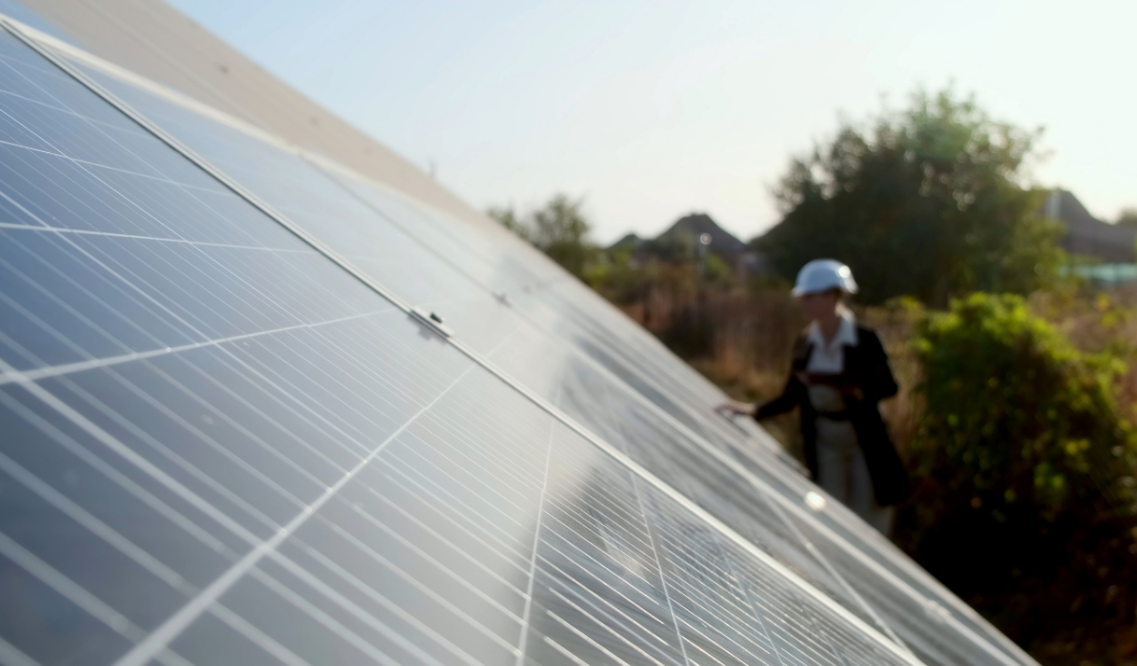 woman infrom of solar panels blurred