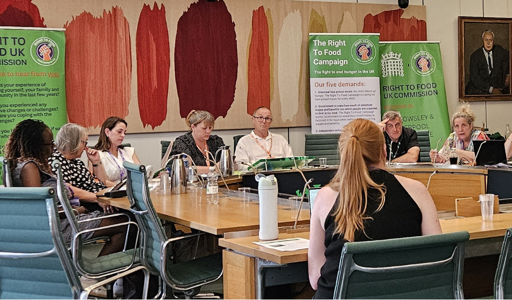 People sitting in a rountable with some banners in the background